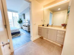 a bathroom with a sink and a mirror at Stunning Apartment By Petco Park! in San Diego