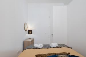 a bedroom with a bed with two towels on it at Luxury Design Apartment - Premium Location in Porto