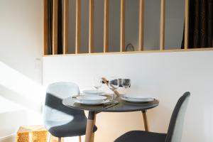 a table with chairs and wine glasses on it at Luxury Design Apartment - Premium Location in Porto