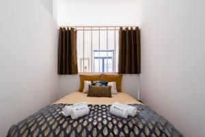 a bedroom with a large bed with two pillows at Luxury Design Apartment - Premium Location in Porto
