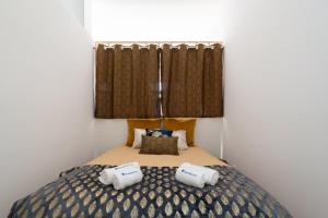 a bedroom with a bed with two pillows on it at Luxury Design Apartment - Premium Location in Porto