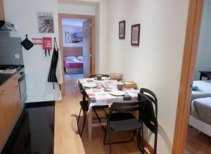 a small kitchen with a table and chairs in a room at Downtown, Cozy Apartment In Lisbon in Lisbon