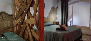 1 dormitorio con 1 cama en una habitación con una pared de piedra en La Impronta Relax en Lleida