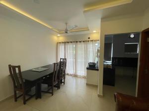 a kitchen and dining room with a table and chairs at BMRAN Luxury serviced apartment in Cochin