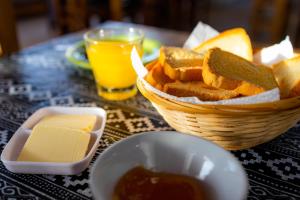 a basket of bread and a basket of butter and cheese at Hotel La Faustina-Caviahue in Caviahue