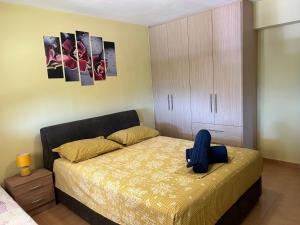 a bedroom with a bed with a stuffed animal on it at Sunshine apartment in Ioannina