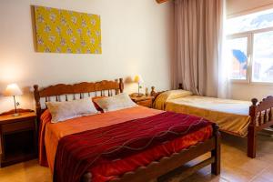 a bedroom with two beds and a window at Hotel La Faustina-Caviahue in Caviahue