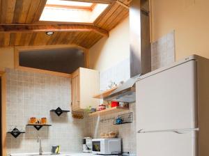 a kitchen with a white refrigerator and a sink at La cuadrita in Uña