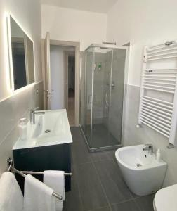 a bathroom with a sink and a glass shower at Titti's House - Parcheggio custodito in garage gratis in Genoa