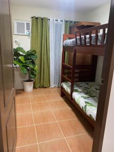 a room with bunk beds and a potted plant at Affordable 2 bedroom condo unit in Cagayan de Oro
