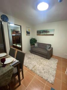 a living room with a couch and a table at Affordable 2 bedroom condo unit in Cagayan de Oro