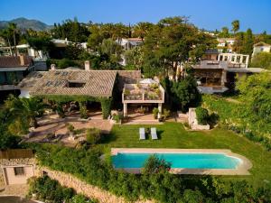 an aerial view of a house with a swimming pool at Character filled villa with mature garden in Marbella