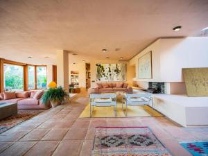 a living room with a couch and a table at Character filled villa with mature garden in Marbella