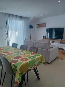 a living room with a table and a couch at Apartamento Santiago de La Ribera in Santiago de la Ribera