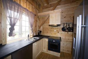 a kitchen with a stove and a sink in a cabin at Grindastugu cabin right by Liatoppen Ski Centre. in Al