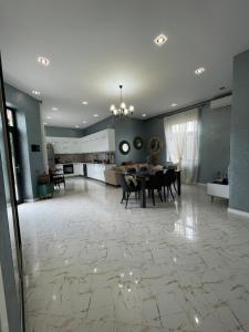 巴庫的住宿－Baku White Villa，一个带餐桌的大客厅和一间厨房