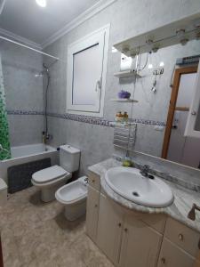 La salle de bains est pourvue d'un lavabo, de toilettes et d'une baignoire. dans l'établissement Piso céntrico reformado de excelente ubicación, à Vinaròs