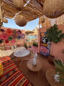 a living room with a couch and tables at Riad Fz Marrakech in Marrakesh