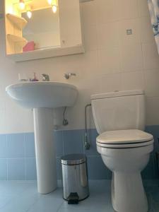 a bathroom with a toilet and a sink at Apollon Sunrise in Apollon