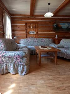 a living room with two couches and a table at Medová chaloupka Jetřichovice České Švýcarsko in Jetřichovice