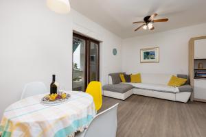 a living room with a table and a couch at Nada in Krk