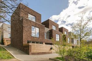 a brick house with a wooden ramp in front of it at A Modern Lavish En-suite Bedroom in London