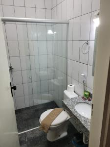 a bathroom with a toilet and a sink at BIGS HOTEL in Penápolis