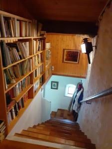 a staircase in a house with bookshelves at La maison du haut in Ponet-et-Saint-Auban