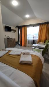a room with three beds with towels on them at MATEVOSYAN`S Rest House in Lermontovo