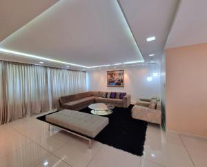 a living room with a couch and a table at Palace Residence in Garanhuns