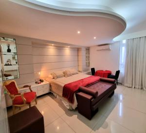 a bedroom with a large bed with a red blanket at Palace Residence in Garanhuns +22 photos