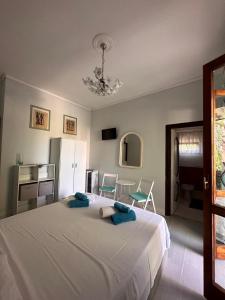 フォンターネ・ビアンケにあるCasa Himera Fontane Biancheのベッドルーム1室(白い大型ベッド1台、青いタオル付)