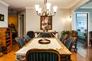a dining room with a table and chairs at Les pieds dans le sable in Chambord