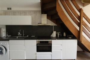 a kitchen with a sink and a stove top oven at 3-star apartment with view in La Clusaz