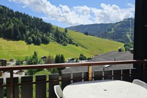 a table on a balcony with a view of a mountain at 3-star apartment with view in La Clusaz