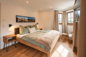 a bedroom with a large bed in a room at Apartments Fliegerbichl - Familie Voithofer in Bramberg am Wildkogel