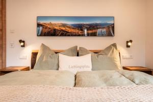 a bedroom with a bed with a television on the wall at Apartments Fliegerbichl - Familie Voithofer in Bramberg am Wildkogel