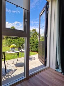 a sliding glass door leading to a patio with a table at Studio Flevo Batavia in Lelystad