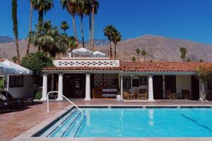 a swimming pool in front of a house at Villa Royale in Palm Springs