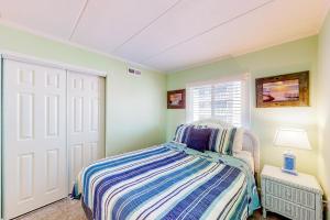 a bedroom with a bed and a window at Assateague House 306 in Ocean City +38 photos