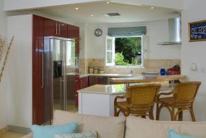 a kitchen with a couch and a kitchen with a counter at Sunny Vacation Villas No 14 in Saint Peter