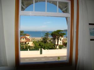 a window with a view of the ocean at Hotel Miramar Playa America Nigran in Nigrán