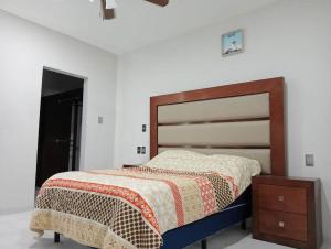a bedroom with a bed with a wooden head board at Hermosa Residencia junto al mar in Veracruz +50 photos
