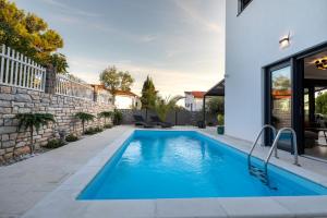 a swimming pool in the backyard of a house at Luxury Villa Adria Apartments in Krk