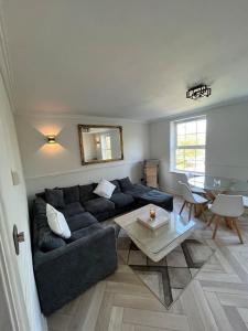 a living room with a couch and a table at Stylish Penarth Marina Apartment in Cardiff