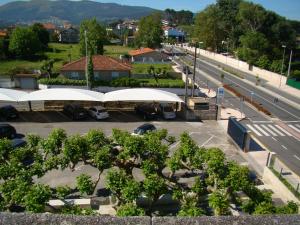 an overhead view of a parking lot with trees and white roofs at Hotel Miramar Playa America Nigran in Nigrán