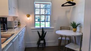 a kitchen with a small table and a window at Whimsical Cottage w/ Pond View in Dundee