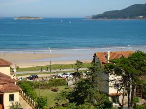 a view of a beach with a group of people at Hotel Miramar Playa America Nigran in Nigrán