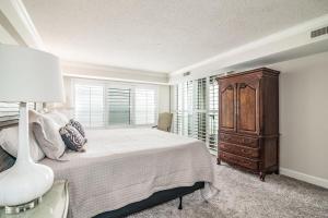 a bedroom with a bed and a dresser and a window at Ocean Vista Retreat Breathtaking View Litchfield in Pawleys Island +15 photos