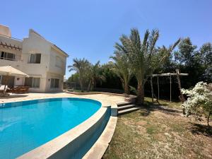 a swimming pool in front of a villa at GS 18 Villa in Hurghada
